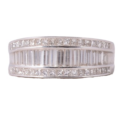 Lot 75 - A modern diamond half hoop ring set with baguette and brilliant diamonds.