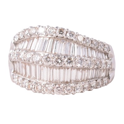Lot 74 - A large diamond half hoop ring set with brilliant and baguette cut diamonds.