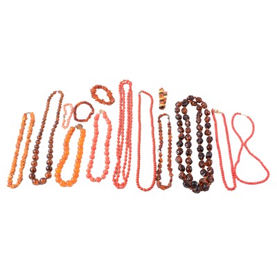 Lot 276 - A collection of amber, faux amber, and coral bead necklaces and bracelets.