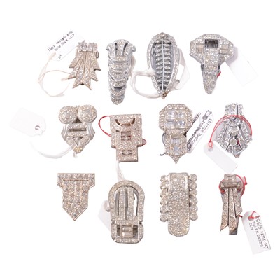 Lot 422 - Twenty-five small Art Deco white metal paste set single dress clips.
