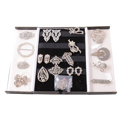 Lot 413 - Twenty-five vintage clear paste brooches, dress clips, buckle and clasp.