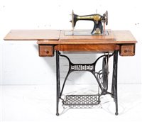 Lot 663 - Singer sewing machine, on cast iron treadle...
