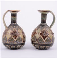 Lot 2 - Doulton Lambeth, a pair of stoneware ewers,...