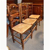 Lot 562 - A pair of ash ladder-back chairs, rushed seats,...