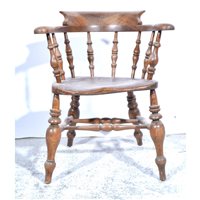 Lot 563 - Elm and beechwood club chair, the back with...