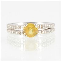 Lot 203 - A yellow sapphire and diamond ring, a 5.8mm...