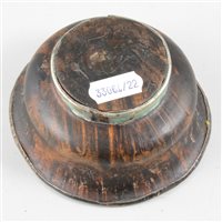 Lot 65 - Tibetan turned wood bowl, with white metal lining and foot-rim.