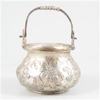 Lot 54 - White metal cauldron-shape bowl with swing handle.