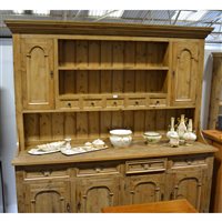 Lot 514 - Reclaimed pine kitchen dresser, two shelf delft rack, with spice drawers and cupboards, the base with four drawers over four arched panelled doors, length 199cm, height 215cm.