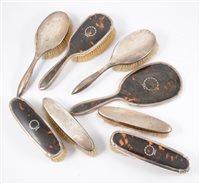 Lot 239 - Pair of silver, tortoiseshell and pique mounted dressing table brushes