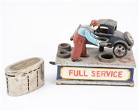 Lot 125 - "Full Service" cast iron novelty money box and a Lloyds Bank money box. (2)