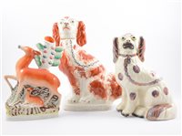 Lot 56 - A pair of Victorian Staffordshire pottery spill vases, modelled with deer