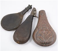 Lot 183 - Two leather shot flasks, and a copper shot flask (3)