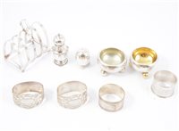 Lot 244 - Silver toast rack by Fenton Brothers (Glasgow) Ltd, Sheffield 1943, pair of Victorian salts possibly by George Fox, London 1874, napkin rings, peppers. (9)