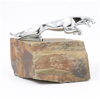 Lot 86 - A Jaguar chrome car mascot, mounted on slate, length 20cm.