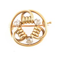 Lot 182 - A yellow metal circular brooch formed from tubular wire and claw set with three old cut diamonds