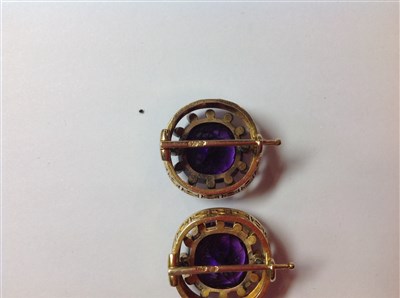Lot 264 - A pair of Fabergé amethyst and diamond lapel brooches