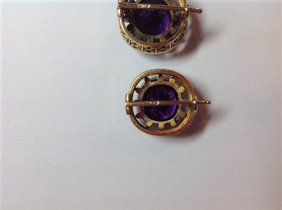 Lot 264 - A pair of Fabergé amethyst and diamond lapel brooches