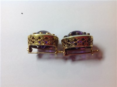 Lot 264 - A pair of Fabergé amethyst and diamond lapel brooches