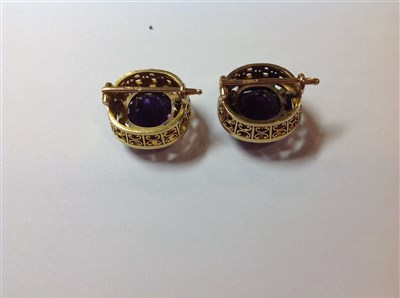 Lot 264 - A pair of Fabergé amethyst and diamond lapel brooches