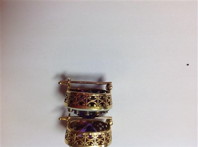 Lot 264 - A pair of Fabergé amethyst and diamond lapel brooches