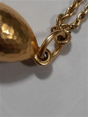 Lot 265 - A Russian yellow metal charm necklace, with two pendants and a locket by Fabergé