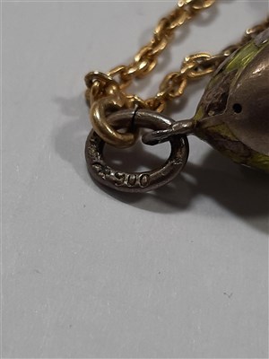 Lot 265 - A Russian yellow metal charm necklace, with two pendants and a locket by Fabergé