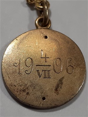 Lot 265 - A Russian yellow metal charm necklace, with two pendants and a locket by Fabergé
