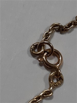 Lot 265 - A Russian yellow metal charm necklace, with two pendants and a locket by Fabergé