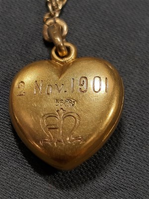 Lot 265 - A Russian yellow metal charm necklace, with two pendants and a locket by Fabergé