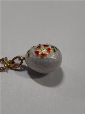 Lot 265 - A Russian yellow metal charm necklace, with two pendants and a locket by Fabergé