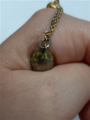 Lot 265 - A Russian yellow metal charm necklace, with two pendants and a locket by Fabergé