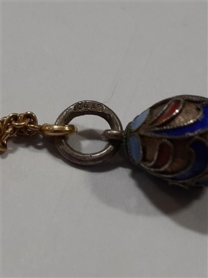 Lot 265 - A Russian yellow metal charm necklace, with two pendants and a locket by Fabergé
