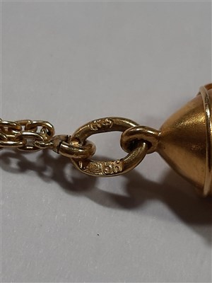 Lot 265 - A Russian yellow metal charm necklace, with two pendants and a locket by Fabergé