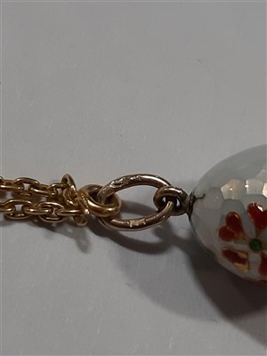 Lot 265 - A Russian yellow metal charm necklace, with two pendants and a locket by Fabergé