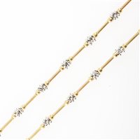 Lot 188 - A 9 carat yellow and white gold necklace, 7mm long polished cylindrical bars spaced by clusters of white gold beads.
