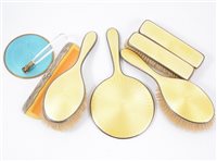 Lot 243 - Silver and yellow enamel dressing table set by W G Sothers Ltd, Birmingham 1929, along with a blue enamelled mirror and a comb. (7)