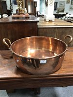 Lot 373 - A large copper twin handled pan, 46cm diameter, 16cm deep.