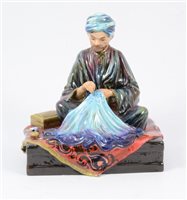 Lot 32 - Reginald Johnson, a hand-painted pottery figure, Embroiderer of Kashmir.
