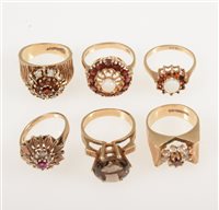 Lot 242 - Six retro 1960's/1970's 9 carat yellow gold gemset dress rings, smoky quartz, garnet, opal and synthetic white spinel, some with bark textured shoulders, ring sizes L-O
