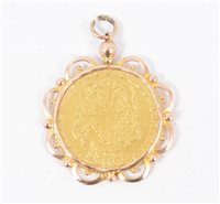Lot 200A - A George II Guinea 1745 in a rose metal scalloped edge mount, gross weight approximately 10.1gms.