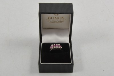 Lot 264 - A ruby and diamond three row ring.