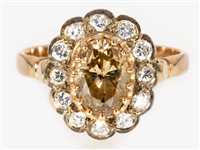 Lot 172 - A cinnamon diamond oval cluster ring