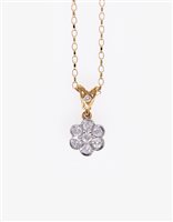 Lot 185 - A diamond cluster pendant, seven brilliant cut diamonds set in an 18 carat yellow and white gold 10.5mm diameter floral mount