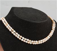 Lot 344 - A two row rope of pink and white slightly oval freshwater pearl, 4.8mm x 4.6mm with gold coloured spacers, overall length 75cm.