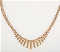 Lot 245 - A 9 carat yellow gold fringe necklace, the bark textured bars tapering from 15mm to 2mm and supported by a three row bar link collar 46cm long, hallmarked Birmingham 1977, approximate weight 25.4gms.