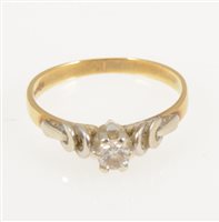 Lot 238 - A diamond solitaire ring, the brilliant cut stone claw set in an 18 carat yellow and white gold mount with raised white gold shoulders