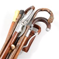 Lot 73 - Shooting stick, Mills Munitions Ltd, Birmingham, three other shooting sticks, walking sticks, a crop, etc.