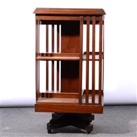Lot 522 - An Edwardian walnut revolving bookcase, square top, vertical rails, width 51cm, height 91cm.