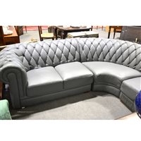 Lot 497 - Contemporary buttoned grey leather modular corner fitting Chesterfield, comprising a two seater section, 135cm; three seater section, 190cm; and a corner quadrant, (3).